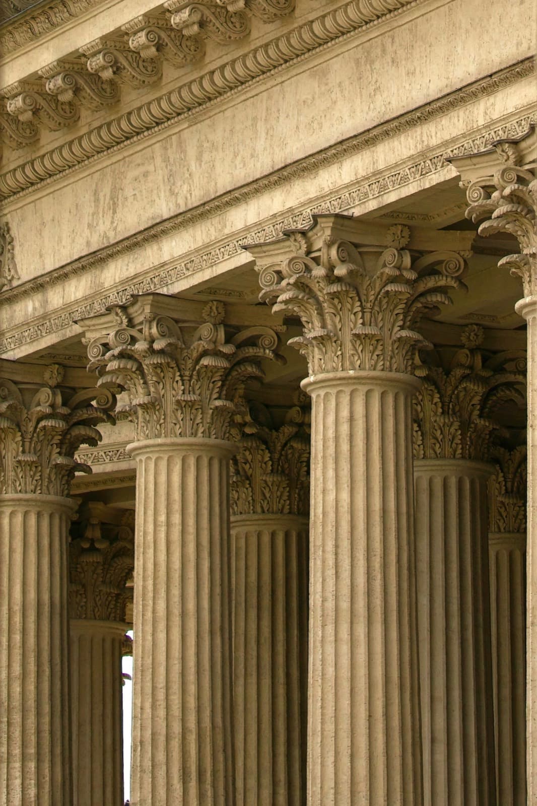 Fluted stone columns with carved capitals beneath a decorated cornice